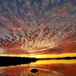 Pink-hued clouds over a lake during sunset