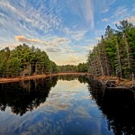 Blue sky and clouds over a lake in the Township of South Algonquin
