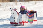 A girl in a unicorn toboggan at the Festival of Outdoor Rinks in Whitney
